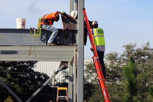 Workers put in a structural steel frame for a company-sized barracks at Fort Jackson, South Carolina as part of the Basic Training Complex Four, Phase Two project.  Formally known as a Basic Combat Trainee Complex, it has all the required...