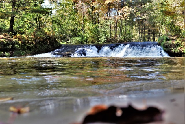 A scene of Trout Falls on the La Crosse River in the Pine View Recreation Area is shown with fall colors Sept. 30, 2021, at Fort McCoy, Wis. The recreation area includes acres of publicly accessible land with hiking trails, Pine View Campground, Whitetail Ridge Ski Area, and Sportsman’s Range. Pine View Recreation Area offers four-season, year-round activities to include camping, hiking, fishing, and more. See more about the area at https://mccoy.armymwr.com/categories/outdoor-recreation. (U.S. Army Photo by Scott T. Sturkol, Public Affairs Office, Fort McCoy, Wis.)