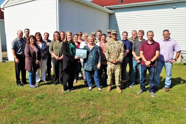 Members of the Fort McCoy Resource Management Office (RMO) and the Fort McCoy Garrison command team (Garrison Commander Col. Michael Poss, Deputy Garrison Commander Lt. Col. Chad Maynard, and Command Sgt. Maj. Raquel DiDomenico) stop for a photo Sept. 30, 2021, as RMO team members are recognized for excellence with a Garrison Command Team Certificate of Excellence at Fort McCoy, Wis. The RMO team recently completed the busy end-of-fiscal-year budget cycle and were holding an organizational day when they were recognized for their work during fiscal year 2021. Bonnie Hilt and Maureen Richardson of RMO are shown holding the certificate. (U.S. Army Photo by Scott T. Sturkol, Public Affairs Office, Fort McCoy, Wis.)