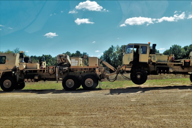 Soldiers at Fort McCoy, Wis., for training in the Regional Training Site-Maintenance Wheeled-Vehicle Recovery Operations Course work together during training Sept. 23, 2021, at the installation Vehicle Recovery Site on North Post. The 17-day...