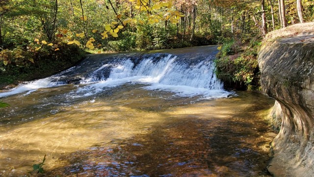 A scene of Trout Falls on the La Crosse River in the Pine View Recreation Area is shown with fall colors Sept. 30, 2021, at Fort McCoy, Wis. The recreation area includes acres of publicly accessible land with hiking trails, Pine View Campground, Whitetail Ridge Ski Area, and Sportsman’s Range. Pine View Recreation Area offers four-season, year-round activities to include camping, hiking, fishing, and more. See more about the area at https://mccoy.armymwr.com/categories/outdoor-recreation. (U.S. Army Photo by Scott T. Sturkol, Public Affairs Office, Fort McCoy, Wis.)