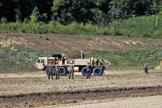 Soldiers at Fort McCoy, Wis., for training in the Regional Training Site-Maintenance Wheeled-Vehicle Recovery Operations Course work together during training Sept. 23, 2021, at the installation Vehicle Recovery Site on North Post. The 17-day...