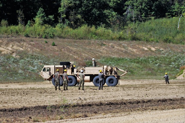 Soldiers at Fort McCoy, Wis., for training in the Regional Training Site-Maintenance Wheeled-Vehicle Recovery Operations Course work together during training Sept. 23, 2021, at the installation Vehicle Recovery Site on North Post. The 17-day course covers operation and maintenance of recovery vehicles and use of standard procedures to rig and recover wheeled vehicles. Related training tasks include oxygen and acetylene gas welding; boom and hoist operations; winch operations; and recovery of mired, overturned, and disabled vehicles. RTS-Maintenance holds several sessions of the Wheeled-Vehicle Operations Course each year and trains Soldiers from both active- and reserve-component forces. (U.S. Army Photo by Scott T. Sturkol, Public Affairs Office, Fort McCoy, Wis.)