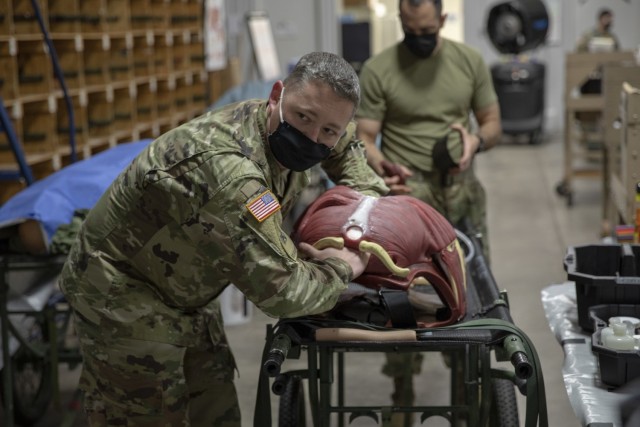 Cpt. Chad Warren, an officer with the 7301st Medical Training Support Battalion, prepares the cut suit to go into the field at Fort McCoy, Wisconsin, Aug. 14, 2021. These training tools are used in the Combat Support Training Exercise, which the 78th Training Division is executing this rotation. (US Army Reserve Photo by Sgt. Sarah Martens)