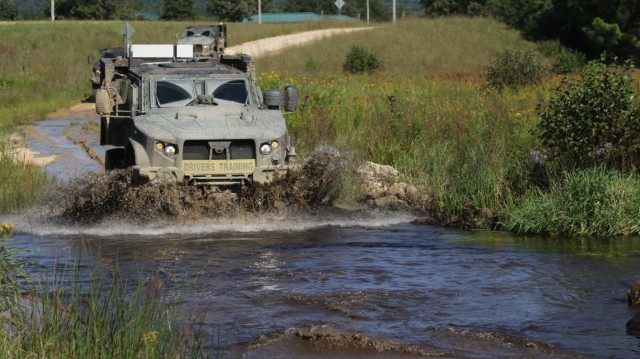 Joint Light Tactical Vehicle driver's training students learn about the fording capabilities of the JLTV while driving through a small river at Fort McCoy, Wis., Sept. 1, 2021. (U.S. Army photo by Sgt. Bill Washburn/88th Readiness Division)