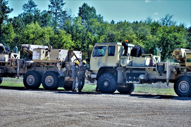 Soldiers at Fort McCoy, Wis., for training in the Regional Training Site-Maintenance Wheeled-Vehicle Recovery Operations Course work together during training Sept. 23, 2021, at the installation Vehicle Recovery Site on North Post. The 17-day course covers operation and maintenance of recovery vehicles and use of standard procedures to rig and recover wheeled vehicles. Related training tasks include oxygen and acetylene gas welding; boom and hoist operations; winch operations; and recovery of mired, overturned, and disabled vehicles. RTS-Maintenance holds several sessions of the Wheeled-Vehicle Operations Course each year and trains Soldiers from both active- and reserve-component forces. (U.S. Army Photo by Scott T. Sturkol, Public Affairs Office, Fort McCoy, Wis.)