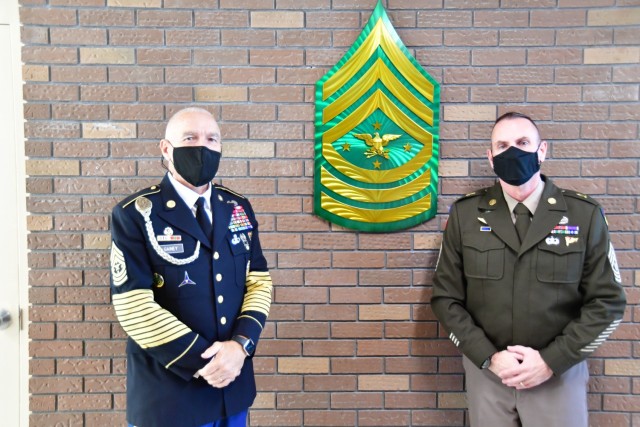 SEAC Joe Gainey (R) presented the NCOLCoE a metal SEAC Rank Insignia to hand in the SEAC Hallway alongside the former SEAC pictures.