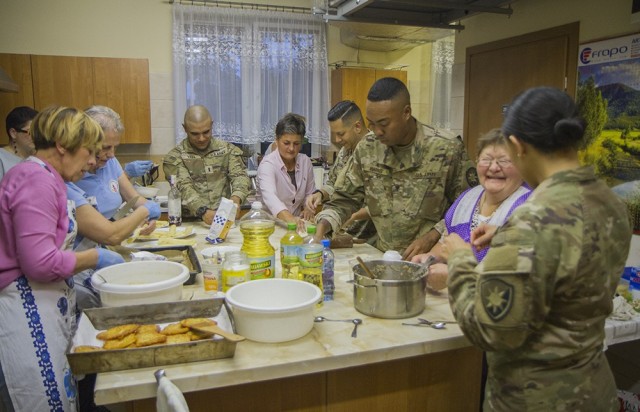 U.S. Army Soldiers assigned to the Florida Guard’s 50th Regional Support Group, work with members of a local women’s organization to prepare traditional Polish dishes at the Powidz Community Center in Powidz, Poland, Oct. 5, 2021. These...