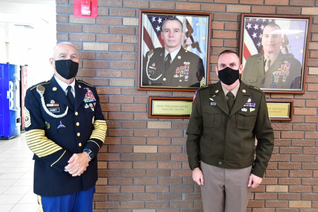 SEAC Joe Gainey and Command Sgt. Maj. Jason Schmidt, NCO Leadership Center of Excellence and Sergeants Major Academy pose for a picture in front of the newly unveiled wall plate.