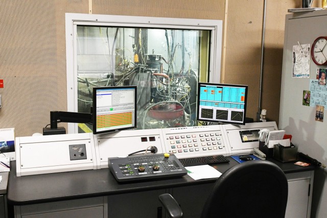 Heavy mobile equipment mechanics operate the dynamometer from the control room of the test cell. The turbine engine remains visible to the mechanic throughout the test procedure.
