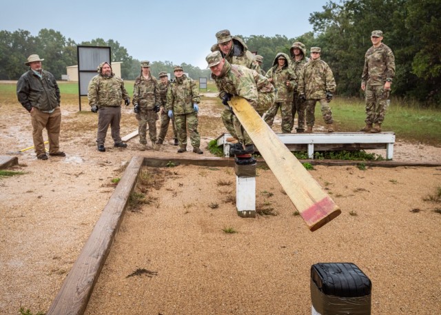 Ryan Spry (in front) and Ben Schreiber, two of the 12 civilians participating in the U.S. Army Corps of Engineers Kansas City District Leader Development Program, attempt to complete one of the obstacles Oct. 6 at the Team Development Course. The...