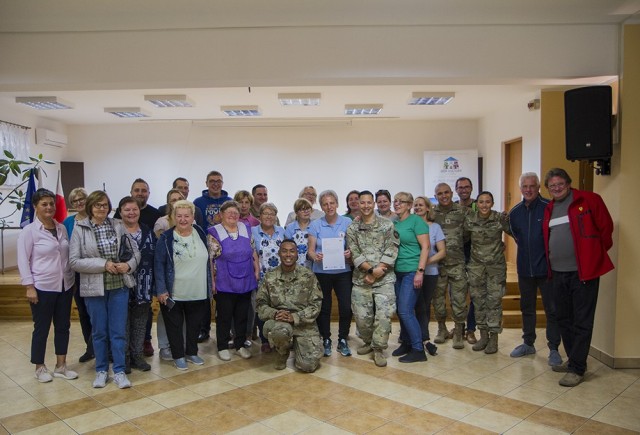 U.S. Army Soldiers assigned to the Florida Guard’s 50th Regional Support Group, enjoy an evening with locals after preparing traditional Polish dishes with members of a local women’s organization at the Powidz Community Center in Powidz,...