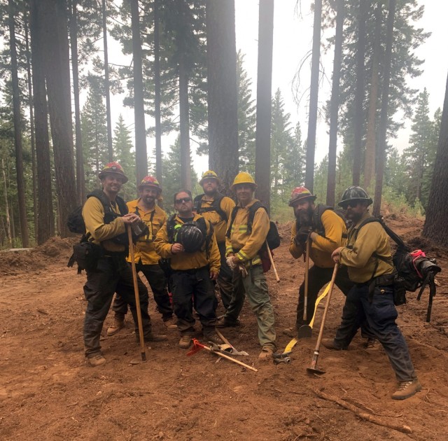 Sierra Army Depot firefighters pause from digging fire break lines to pose for a photo while providing support to local efforts to combat the Dixie Fire, July 2021, in northern California. The Sierra Army Depot fire department was named as the U.S. Army Materiel Command Fire Department of the Year for 2020, partially due to its support to local authorities in combating wildfires during the 2020 wildfire season.