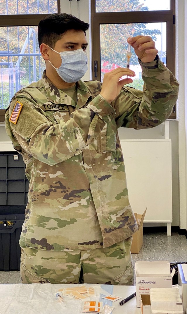 Spc. William Torrez carefully prepares flu shots for Soldiers and civilians receiving the vaccine at the Chapel on Clay Kaserne.