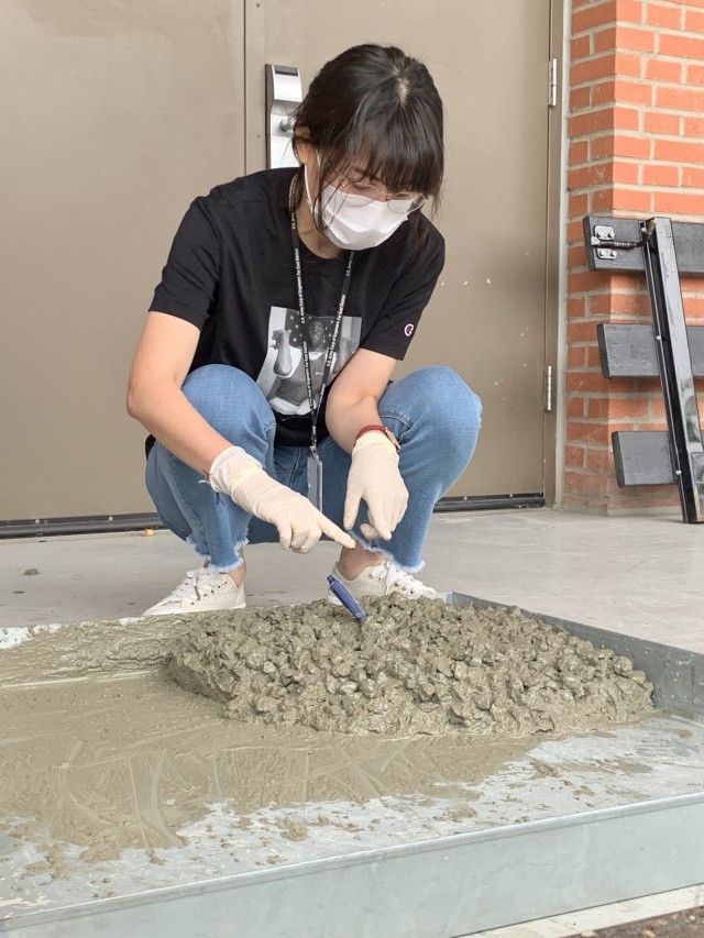 Min Chae Kim, an FED Geotechnical Materials Lab civil engineer, conducts a temperature check on a mix of concrete as part of testing for the American Concrete Institute certification, held at the Far East District Materials Testing Lab, Sept. 30.