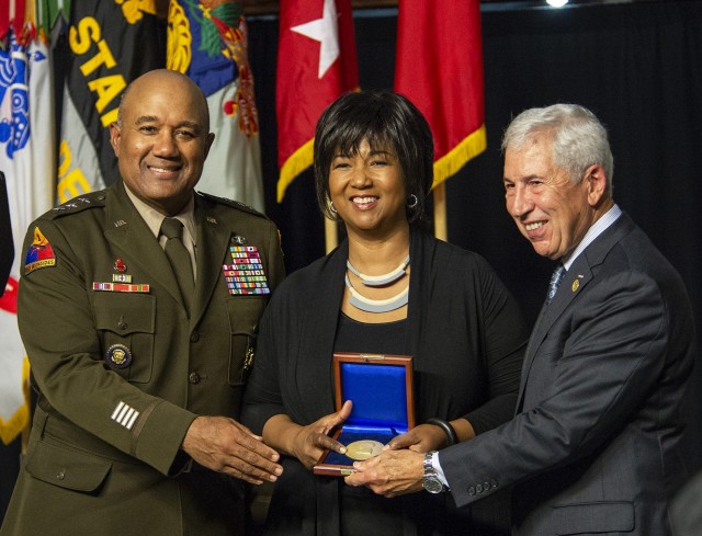 Mae C. Jemison, the 2021 Thayer Award recipient, accepts the Thayer Award from Superintendent Lt. Gen. Darryl A. Williams (left) and retired Lt. Gen. Joseph DeFrancisco, chairman of the West Point Association of Graduates, during the Thayer Award...