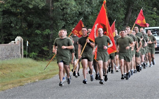 Military personnel from Marine Detachment - Fort Lee, including Operations Officer Capt. Norman Bunch leading the group, approach Christ Church Parish Cemetery during the annual Lt. Gen. Lewis Burwell “Chesty” Puller Run Oct. 13. The Marines started the formation run in Saluda where Puller retired, and it concluded at the cemetery where he and his wife are buried. A ceremony is conducted at the gravesite with reflections about the general’s heroic service and toasts in his honor.