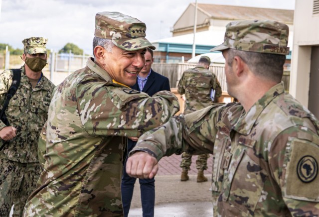 U.S. Army Gen. Stephen Townsend, center left, commander of United States Africa Command, greets U.S. Air Force Chief Master Sgt. Dan Spencer, USAFRICOM J2-M senior enlisted leader, with an elbow bomb after at RAF Molesworth, England, Aug. 25, 2020. Townsend visited Molesworth to gain a better comprehensive understanding of the base as a whole and to visit AFRICOM J-2M. (U.S. Air Force photo by Senior Airman Eugene Oliver)
