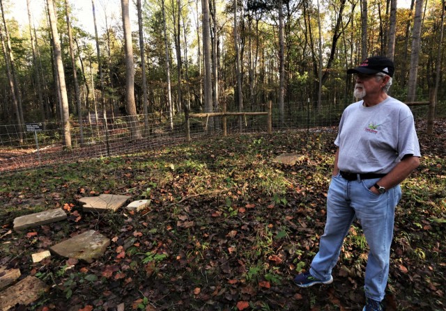 Tim Taylor, a descendant of the Rahm family, stands in his family’s cemetery, which was thought to be lost for half a century.