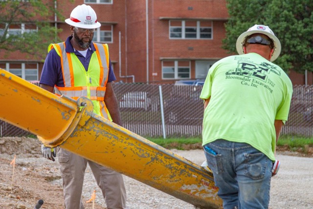 U.S. Army Corps of Engineers, Kansas City District Missouri Resident Office Hospital Quality Assurance and Collateral Duty Safety Officer Percy Williams (left) works collaboratively with a contract construction worker on a road realignment project...