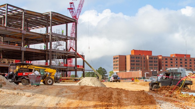 Contractors work on constructing the steel structure forming the main portion of the new hospital on the left, while the current General Leonard Wood Army Community Hospital sits farther back to the right at Fort Leonard Wood, Mo., on Sept. 1,...