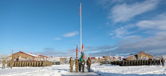 U.S. paratroopers with the 4th Infantry Brigade Combat Team (Airborne), 25th Infantry Division, “Spartan Brigade,” and Indian Army troops from 7th Battalion, The Madras Regiment, “Shandaar Saath,”  hold their nation’s flag during an opening ceremony for exerciseYudh Abhyas 21 Oct., 15, 2021, at Joint Base Elmendorf-Richardson, Alaska. Yudh Abhyas 21 supports the USINDOPACOM Theater Campaign Plan by building readiness through bilateral mil-to-mil engagements consisting of tough realistic training. (U.S. Army photo by Staff Sgt. Alexander Skripnichuk)