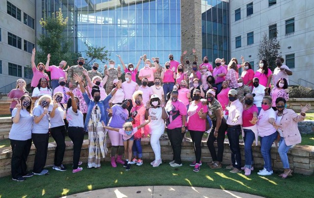 Martin Army Community Hospital staff members strike a pose in pink before walking a mile to raise awareness of breast cancer on National Mammography Day.