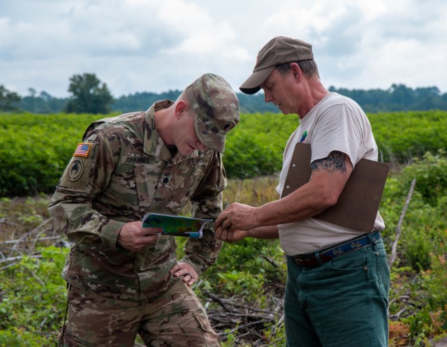 Richard Darden (right), the Regulatory Project Manager for the U.S. Army Corps Of Engineers, Charleston District, explains to Lt. Col. Andrew Johannes how to analyze soil samples during a field visit in Orangeburg, S.C.  Johannes took command of...