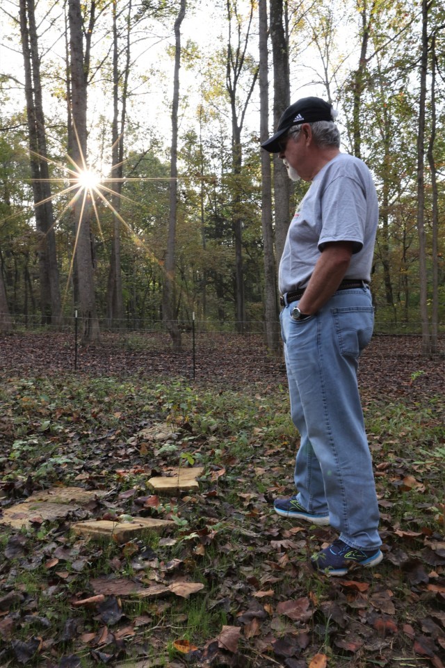 Rahm family descendent Tim Taylor looks over the headstones of his relatives at their family cemetery recently rediscovered at Fort Knox.