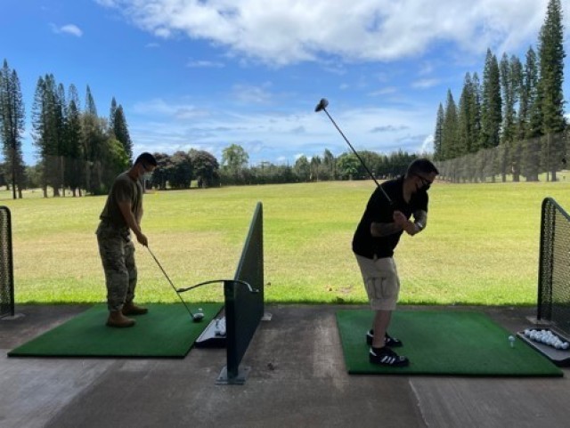 Sgt. Peng Yin (left) and Sgt. Maj. Blair Richards (right) took part in a Golf Skills class at the Leilehua Golf Course in May. The Schofield Barracks Soldier Recovery Unit, Hawaii, offers the class. (Photo courtesy of Carol Hickman)