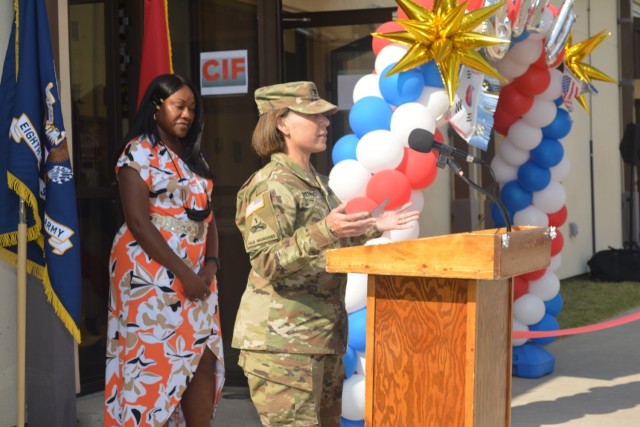 Col. Lisa Rennard, commander, 403rd Army Field Support Brigade, provides remarks as Deon Moss, CIF/OCIE Branch chief, looks on during the Army Field Support Battalion-Korea SPT060 complex grand opening and ribbon cutting ceremony at Camp Humphreys, South Korea, Oct. 14.