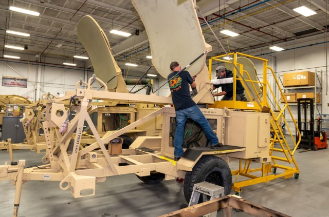 Sheet Metal Mechanics Joe Polny, left, and Jeff Urbanovage replace a lift cable on an AN/TSC-167 Satellite Transportable Terminal (STT). STT overhaul, carried out at Tobyhanna Army Depot since 2013, includes the replacement of cables, line...