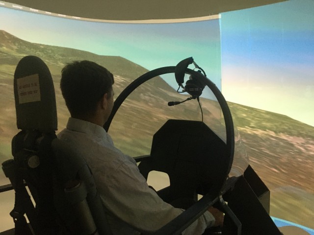Col. Mike Fleming, ITC-Mediterranean director, tests a multirotor aircraft in a flight simulator during a technology scouting visit. UrbanAero, an innovative aircraft company, developed the aircraft with a vision of safe autonomous urban flying vehicles.