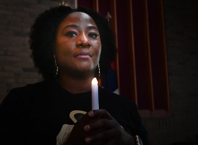 Stacy Ashby holds a candle during the Fort Jackson Candlelight Vigil on Oct. 6, 2021, at the Main Post Chapel. Ashby told her story of being in an abusive relationship and how she almost lost her life at the hands of her abuser.