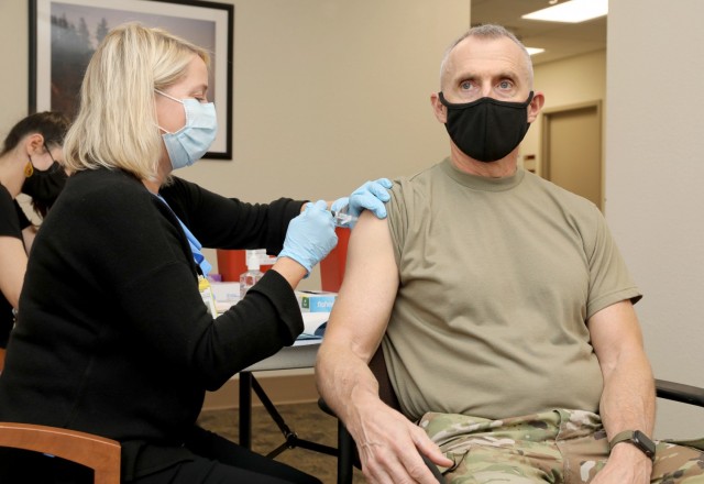 Brig. Gen. Edward H. Bailey, right, commanding general of Regional Health Command-Pacific, Joint Base Lewis-McChord, Wash., receives an influenza vaccination from Susan Chambers, a registered nurse at Madigan Army Medical Center and clinical site manager supporting the Uniformed Services University&#39;s Infectious Disease Clinical Research Program at Madigan. Soldiers and civilian employees receiving flu vaccinations are part of a four-year study to compare the effectiveness of three existing vaccines in preventing influenza infection. 