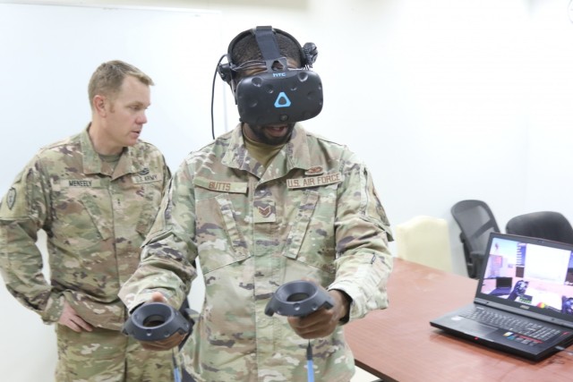 Staff Sgt. Daniel Butts, with the 386th Expeditionary Security Forces Squadron, trains with a SPECTRE Virtual Reality Trainer during a counter-unmanned aerial system (CUAS) course at Camp Buehring, Kuwait. Course instructor Chief Warrant Officer 2 Anthony Meneely stands behind him.