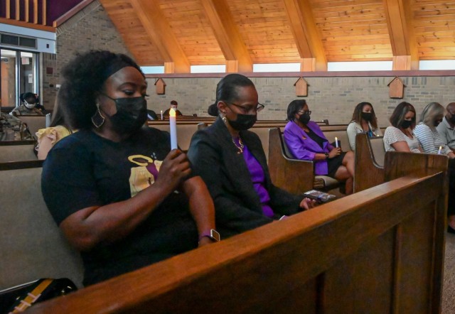 Stacy Ashby holds a candle during the Fort Jackson Candlelight Vigil on Oct. 6, 2021, at the Main Post Chapel. Ashby told her story of being in an abusive relationship and how she almost lost her life at the hands of her abuser.