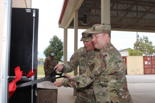 Col. William Parker, commander, 30th ADA Brigade and Col. Cory Berg, commander, Program Executive Office of simulation training and instrumentation, cut the ribbon to open the new Stinger Training Dome Oct. 12, 2021, at Patterson Hall on Fort Sill.