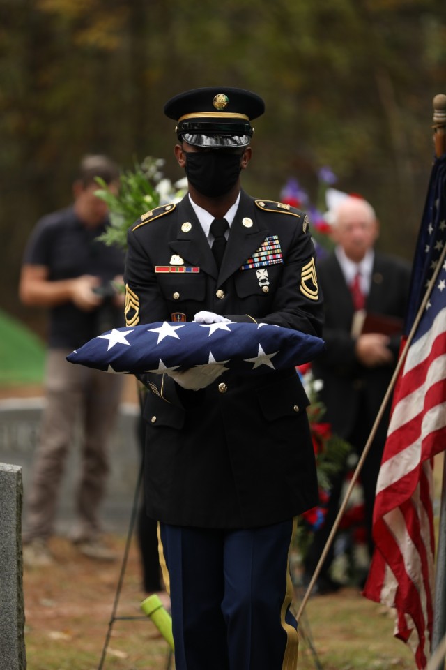 Soldiers with the North Carolina National Guard’s Military Funeral Honors fold the flag that had been drapped over the coffin of 1st Lt. James E. Wright, during a graveside service in his honor at the Oakdale Cemetery in Lumber Bridge, North Carolina on Oct. 12, 2021. Wright, who had served with the NCNG’s 120th Infantry Regiment and grew up in Lumber Bridge, was killed in action in the vicinity of Dornot, France on Sept. 10, 1944. Wright was previously listed as missing in action until recently when his remains were identified through DNA testing. (U.S. Army Photo by Sgt. 1st Class Mary Junell)