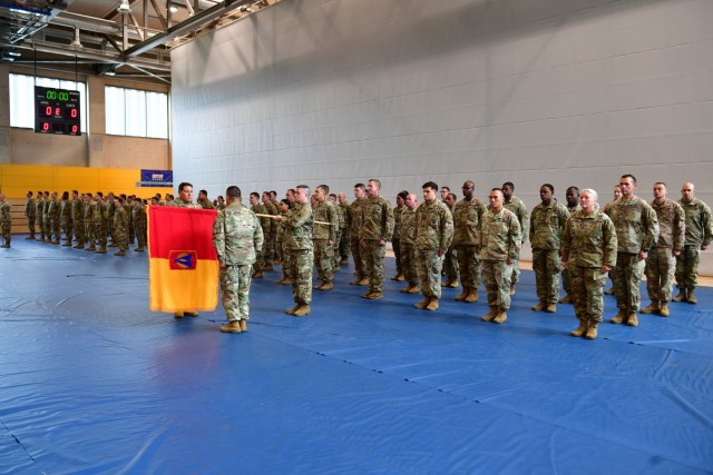 The 164th Air Defense Artillery Brigade, led by Col. Patrick Thompson and Command Sgt. Maj. Jason Junkins, uncase their colors Oct. 18 in a ceremony at the Katterbach Fitness Center. The brigade begins a nine-month deployment as the air defense mission command element in support of the 10th Army Air and Missile Defense Command as part of the U.S. Army Europe-Africa air defense regionally allocated force. (U.S. Army Photo by Sgt. Cesar Rivas)
