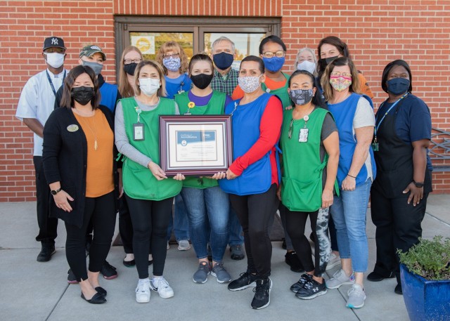 Child care providers at Child Development Center 408 display their National Association for the Education of Young Children accreditation certificate. The Army requires all Child Youth Services programs to have national accreditation to show that...