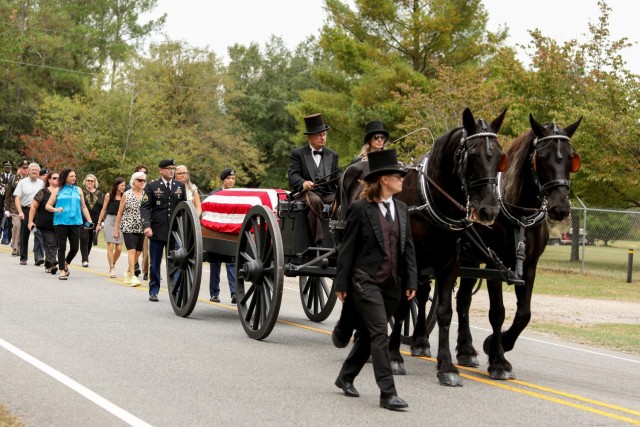A funeral caisson carries the remains of 1st Lt. James E. Wright one mile in a procession from the Lumber Bridge Baptist Church to the Oakdale Cemetery in Lumber Bridge, North Carolina on Oct. 12, 2021. Wright, who had served with the NCNG’s 120th Infantry Regiment and grew up in Lumber Bridge, was killed in action in the vicinity of Dornot, France on Sept. 10, 1944. Wright was previously listed as missing in action until recently when his remains were identified through DNA testing. (U.S. Army Photo by Sgt. 1st Class Mary Junell)