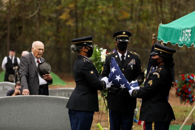 Soldiers with the North Carolina National Guard’s Military Funeral Honors fold the flag that had been drapped over the coffin of 1st Lt. James E. Wright, during a graveside service in his honor at the Oakdale Cemetery in Lumber Bridge, North Carolina on Oct. 12, 2021. Wright, who had served with the NCNG’s 120th Infantry Regiment and grew up in Lumber Bridge, was killed in action in the vicinity of Dornot, France on Sept. 10, 1944. Wright was previously listed as missing in action until recently when his remains were identified through DNA testing. (U.S. Army Photo by Sgt. 1st Class Mary Junell)
