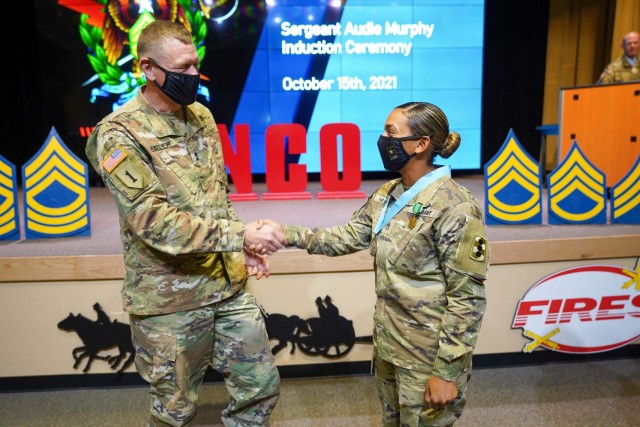 Maj. Gen. Ken Kamper, Fires Center of Excellence and Fort Sill commanding general, congratulates Senior Drill Sergeant (Staff Sgt.) Shanika Haws on her induction into the Sergeant Audie Murphy Club, Oct. 15, 2021.