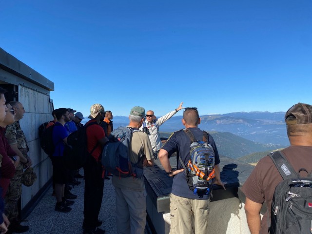 Italian retired Brig. Gen. Edoardo Maggian, center, provides an orientation of the landscape at the Monte Grappa Summit in Crespano del Grappa, Italy, during a U.S. Army Southern European Task Force - Africa G4 staff ride Sept. 25, 2021.  The SETAF-AF G4 conducted a two-day staff ride focused on the Italian military campaign in WWI; the event concluded with a hike on Monte Grappa, where the Italian army fought three decisive battles against German and Austro-Hungarian forces during 1917-18. 