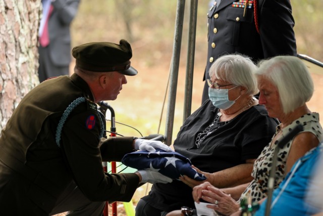 Col. Wes Morrison, commander of the North Carolina National Guard’s 30th Armored Brigade Combat Team, presents folded flags to the family of 1st Lt. James E. Wright, during a graveside service in his honor at the Oakdale Cemetery in Lumber Bridge, North Carolina on Oct. 12, 2021. Wright, who had served with the NCNG’s 120th Infantry Regiment and grew up in Lumber Bridge, was killed in action in the vicinity of Dornot, France on Sept. 10, 1944. Wright was previously listed as missing in action until recently when his remains were identified through DNA testing. (U.S. Army Photo by Sgt. 1st Class Mary Junell)