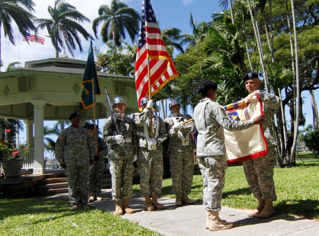 Col. Robert Dawson, the outgoing 402nd Army Field Support Brigade commander and Command Sgt. Maj. Cheryl Green, the outgoing command sergeant major, uncase the units colors at the Historic Palm Circle gazebo, Fort Shafter, Aug. 3. This is the...