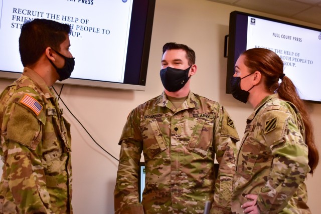 From left to right, Spc. Joseph Jennings, a Soldier assigned to 3rd Combat Aviation Brigade, 3rd Infantry Division, Spc. Dalton Richardson, a Soldier assigned to 3rd Infantry Division Artillery, and Spc. Ivy Simms, a Soldier assigned to 3rd ID Artillery, enact a crisis intervention scenario during the Marne Guardian course, Oct. 14, 2021, on Fort Stewart, Georgia. The Marne Guardian course teaches junior enlisted Soldiers how to support their peers and inform them of available resources when they need help with issues such as harassment and suicidal ideation. The goal is to have one Marne Guardian in every 3rd ID company, troop and battery. (U.S. Army photo by Spc. William Griffen)