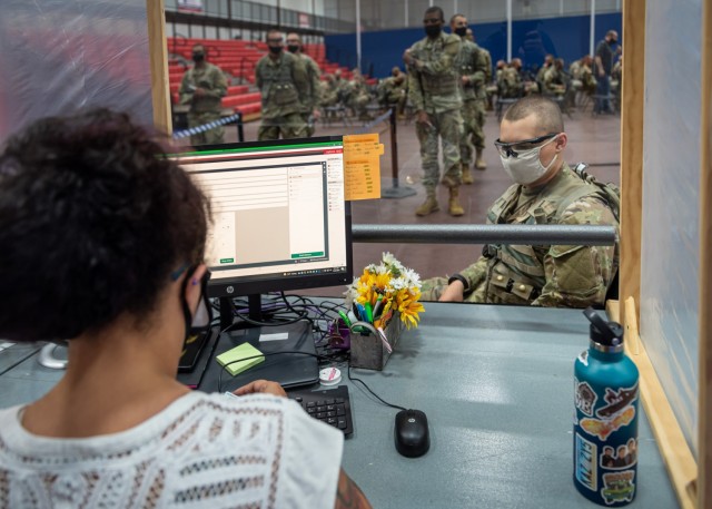 Trainees with Company B, 795th Military Police Battalion, finalize travel itineraries with family and friends and purchase bus and airline tickets Wednesday at Davidson Fitness Center for the annual Holiday Block Leave. Thousands of Soldiers,...