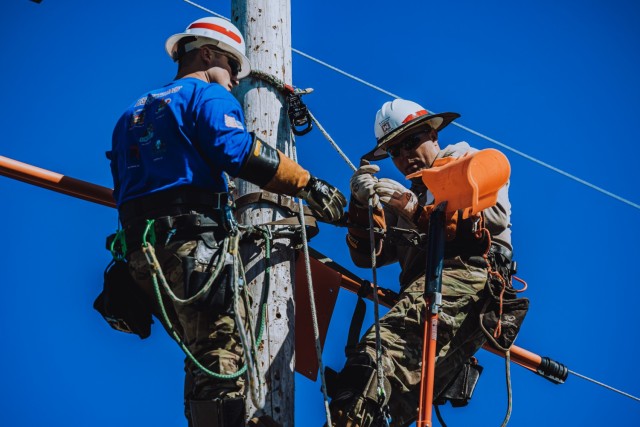 Staff Sgt. Joseph Hak & Staff Sgt. Patrick Miller, Soldiers assigned to the Delta Company, 249th Engineer Battalion, Prime Power are competing in the Journeyman Mystery Event 2 in the International Lineman's Rodeo alongside industry professionals...